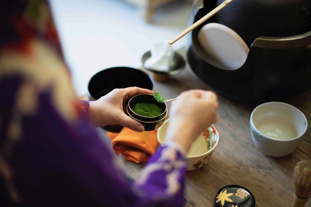 Scooping Matcha with a chashaku for a tea ceremony